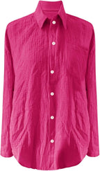 Bright pink textured blouse displayed against a white background.
