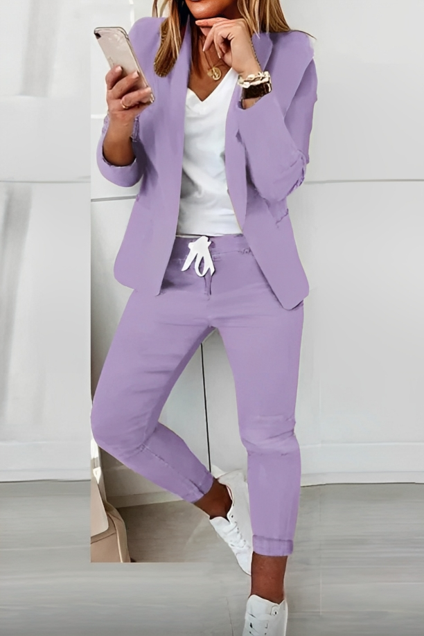 Purple open-front blazer and drawstring trousers shown with a contrasting top and white trainers.