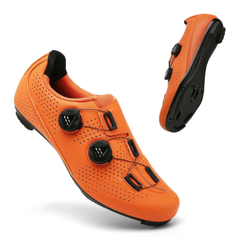 Orange cycling shoes with two black dials and a sole view.