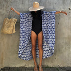 Sapphire-blue leaf-print cover-up shown with wide sleeves spread.