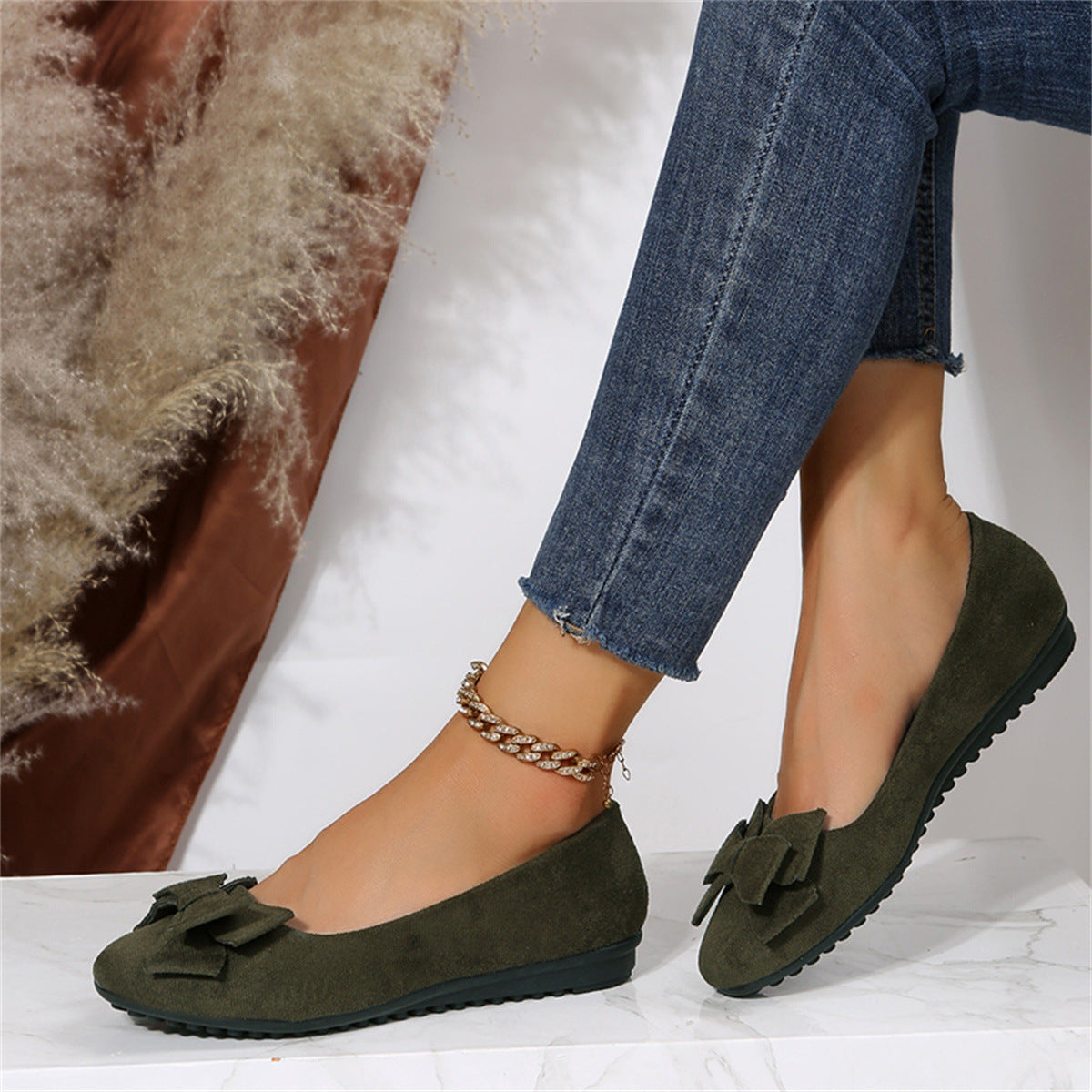Side view of dark green bow-front flats.