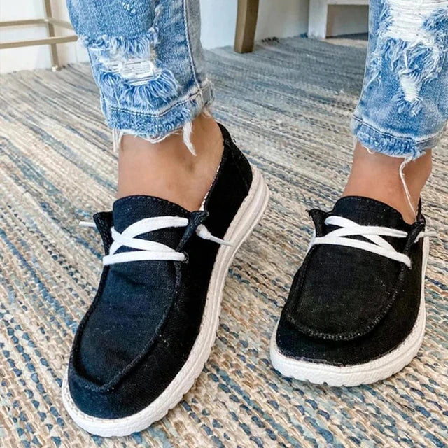 Black casual shoes with short white laces.