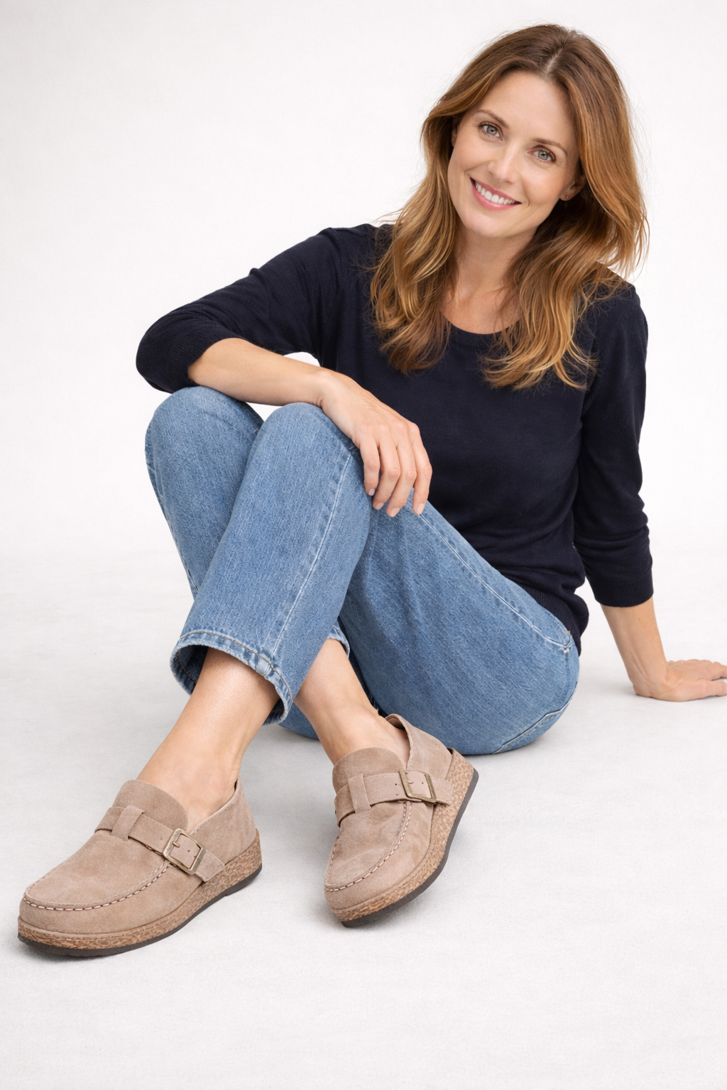 Tan buckle clogs worn with jeans.