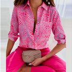 Pink heart-print blouse with a button front.