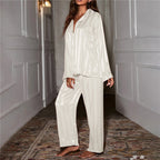 Ivory striped satin pyjama set with a collared shirt and long trousers.