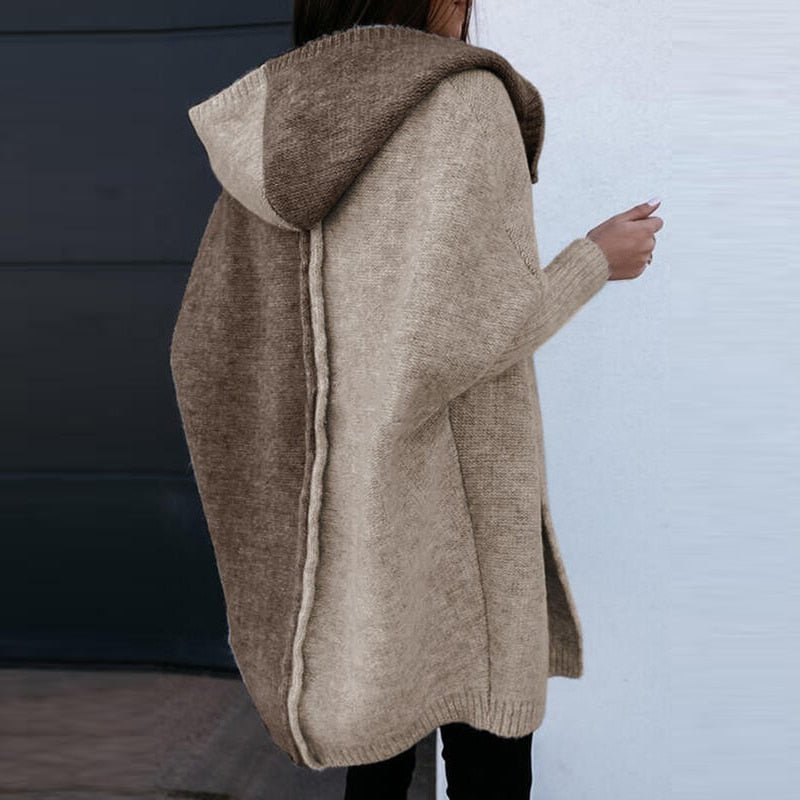 Rear view of the long cardigan showing contrasting brown panels and hood.