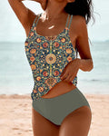 Green tankini with an asymmetric floral top and double shoulder straps.