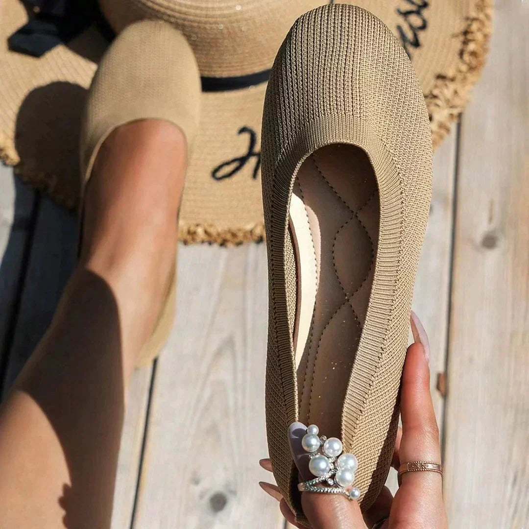 Khaki flat held beside its matching worn shoe.
