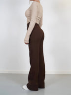 Side view of brown high-waist trousers with wide legs.