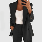Close view of a black single-button blazer and trouser set.