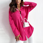 Bright pink blouse with a pointed collar and loose sleeves.
