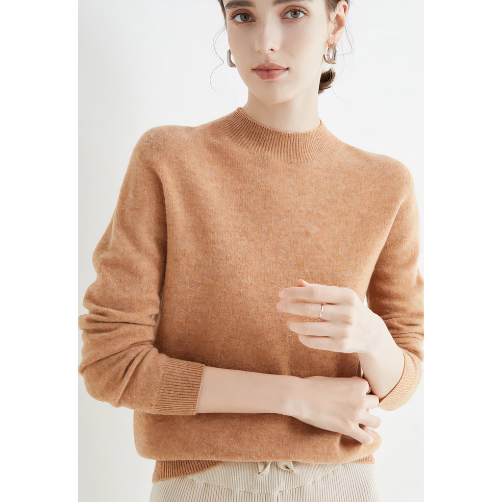 Warm tan-gold jumper showing ribbed cuffs.