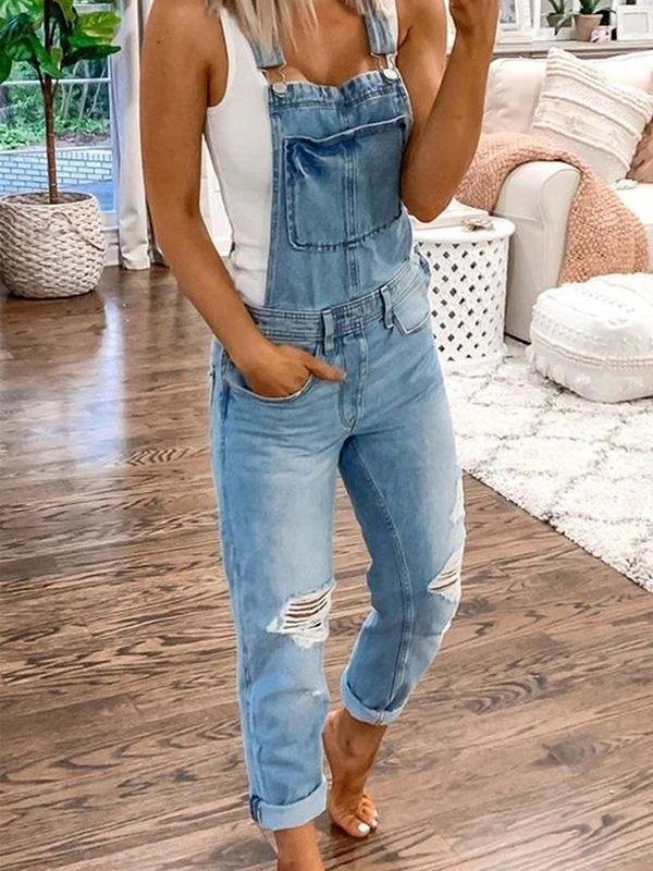 Light blue bib overalls worn over a separate white top.