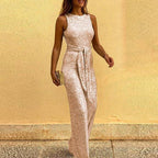Pale pink sequin jumpsuit with a waist tie and long wide legs.