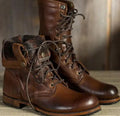 Brown lace-up boots shown with one cuff folded to reveal the lining.