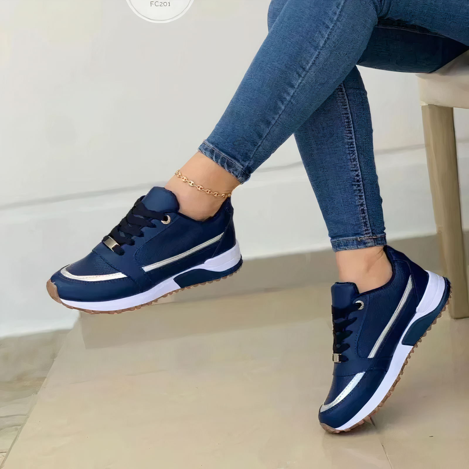 Navy lace-up trainers with silver-coloured trim and contrasting white sole sections.