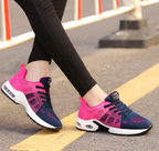Dark blue and bright pink trainers with black laces.