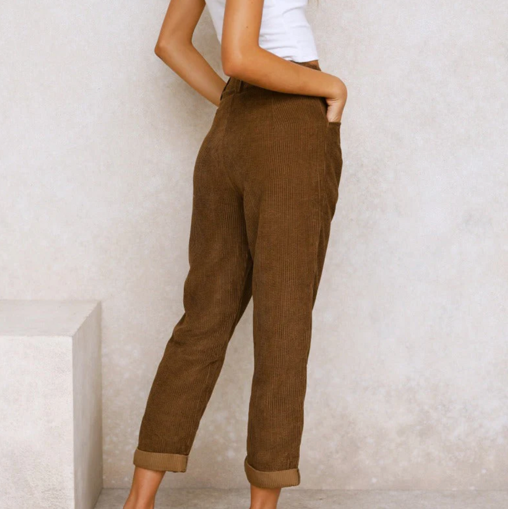 Rear view of brown ribbed trousers.