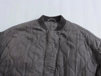 Close-up of the ribbed collar and round front fastenings.