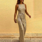 Gold sequin jumpsuit with a round neckline, sleeveless cut and fabric waist tie.