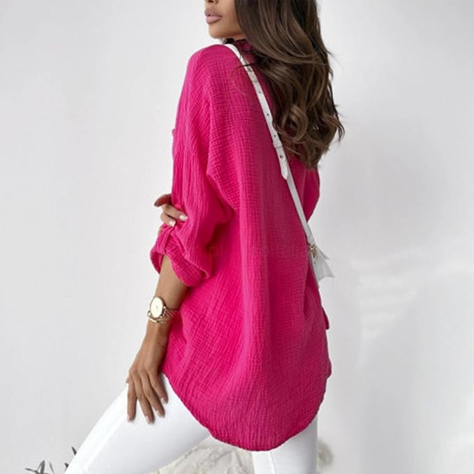 Rear side view of a bright pink blouse with a rounded hem.