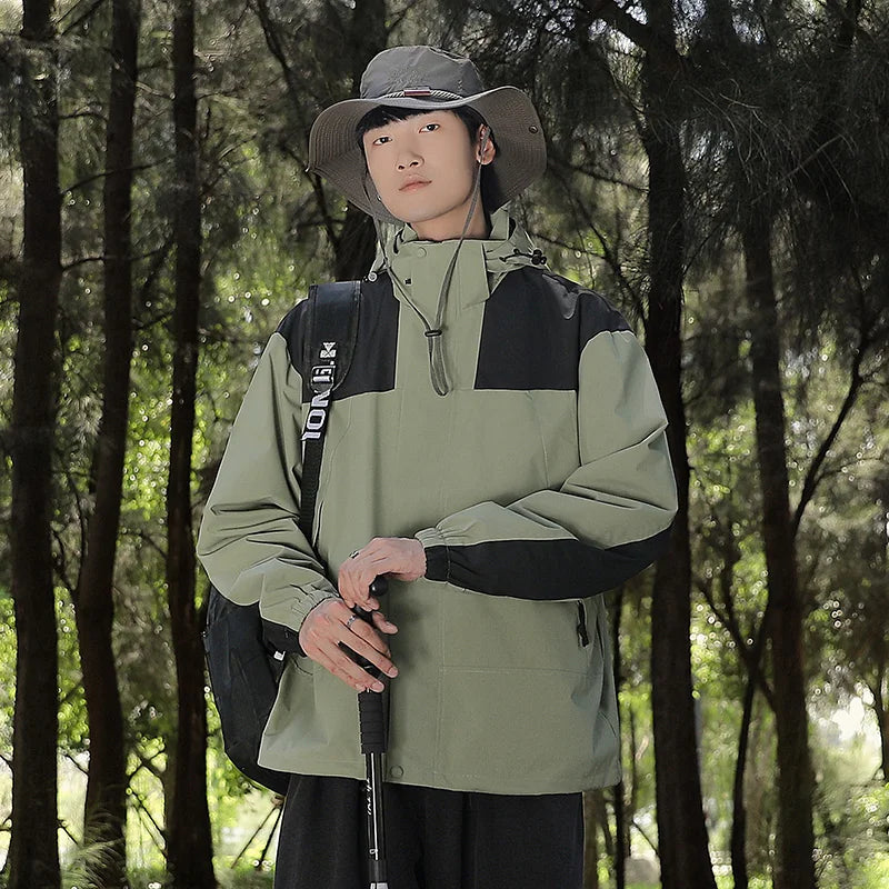 Green jacket worn outdoors, showing black shoulder and sleeve panels.