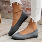 Side view of grey slip-on flats.
