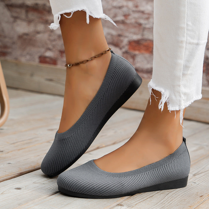 Side view of grey slip-on flats.