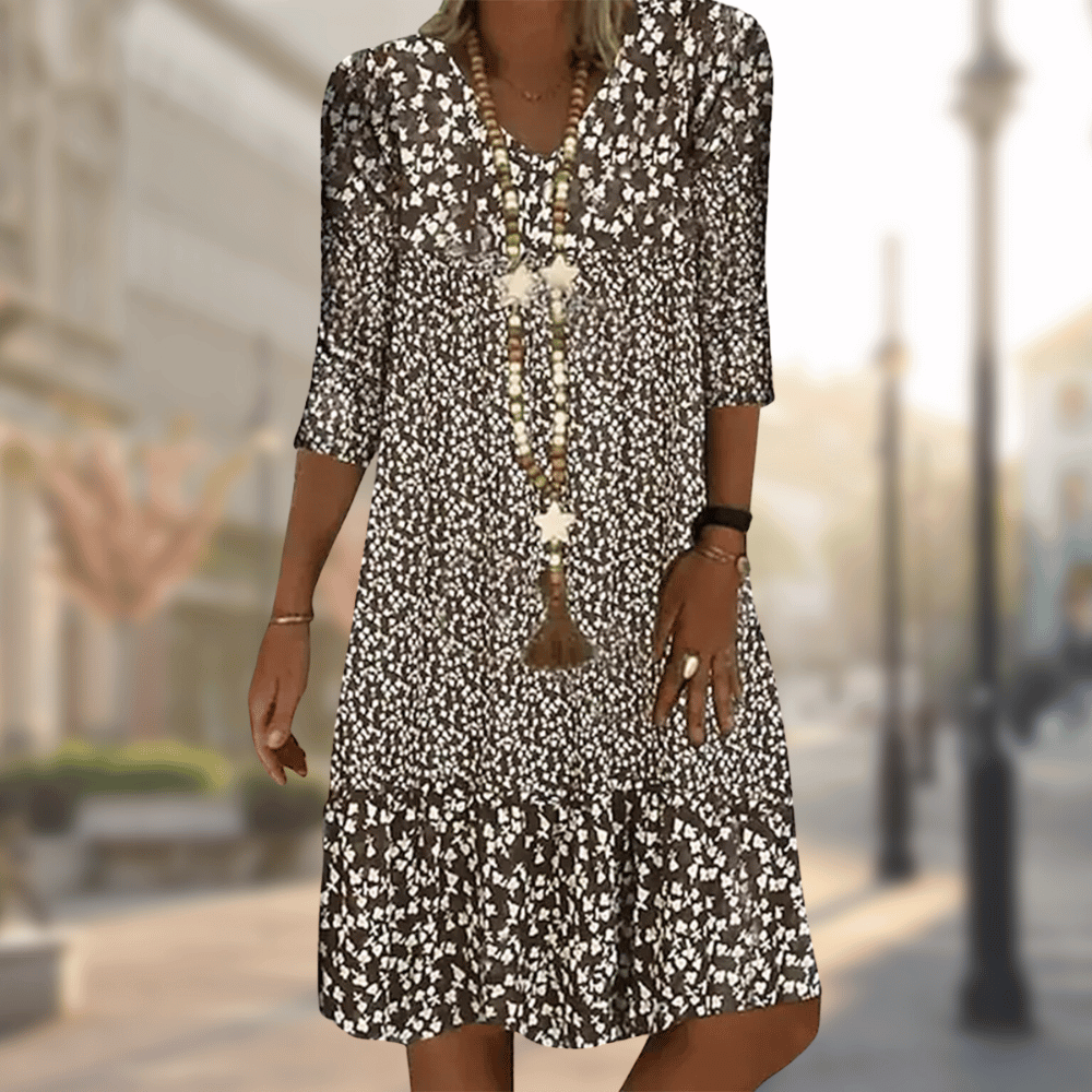 Brown floral dress with three-quarter sleeves and a loose body.