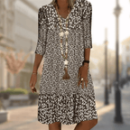 Brown floral dress with three-quarter sleeves and a loose body.