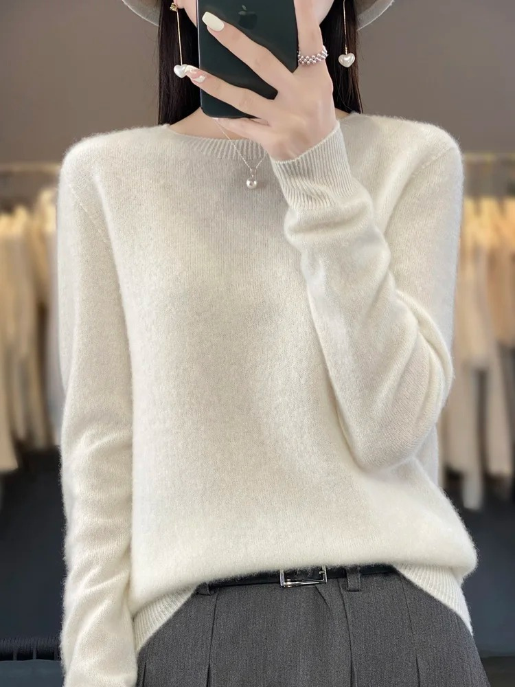 White jumper with ribbed cuffs and a rounded neckline.