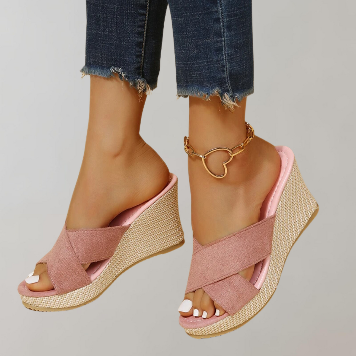 Pink wedge sandals shown from the front.