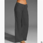 Grey wide-leg trousers shown with bare feet.