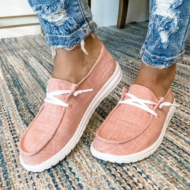 Pink casual lace-up shoes with stitched toe panels.