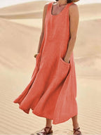 Orange sleeveless dress with a flowing skirt and large front pockets.