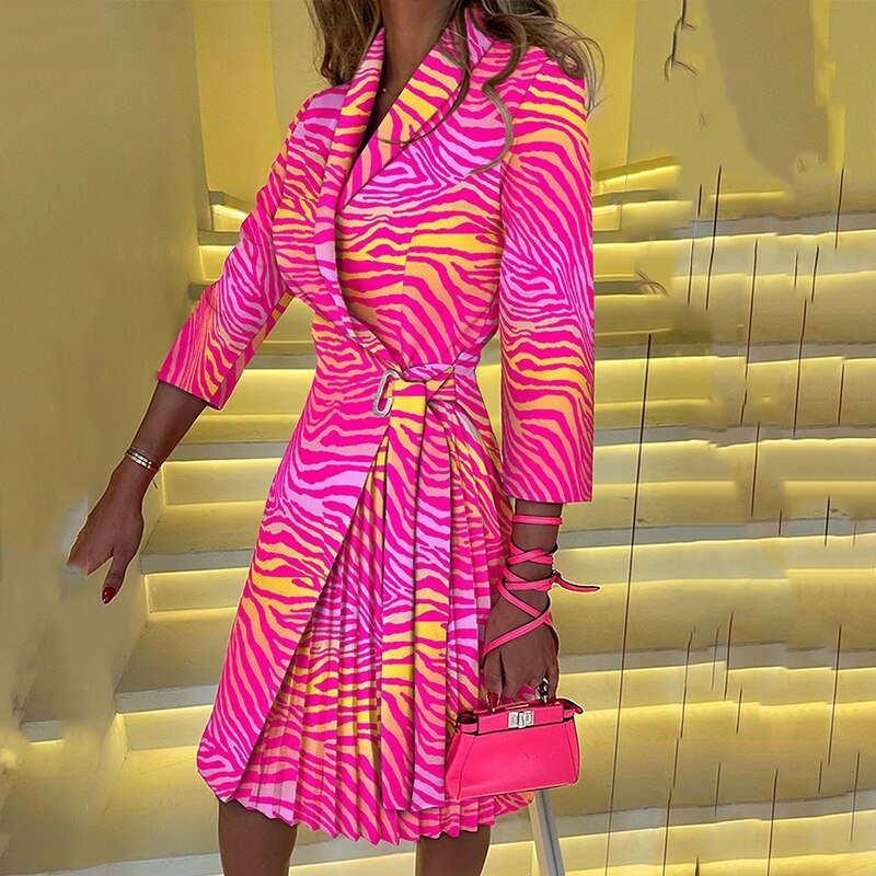 Pink and yellow striped blazer dress with a pleated skirt panel.
