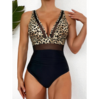 Leopard-print and black swimsuit worn in front of a white wall.