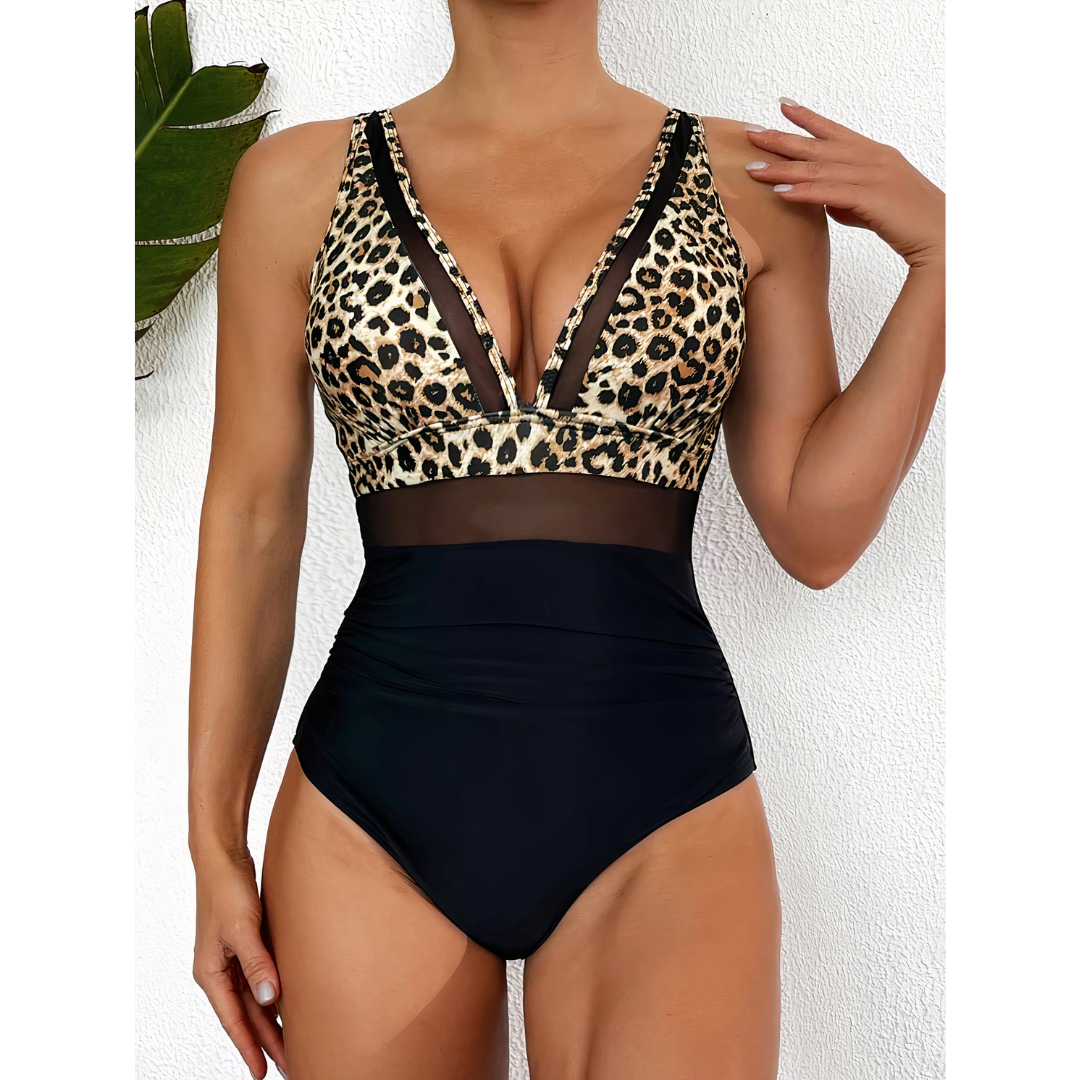 Leopard-print and black swimsuit worn in front of a white wall.