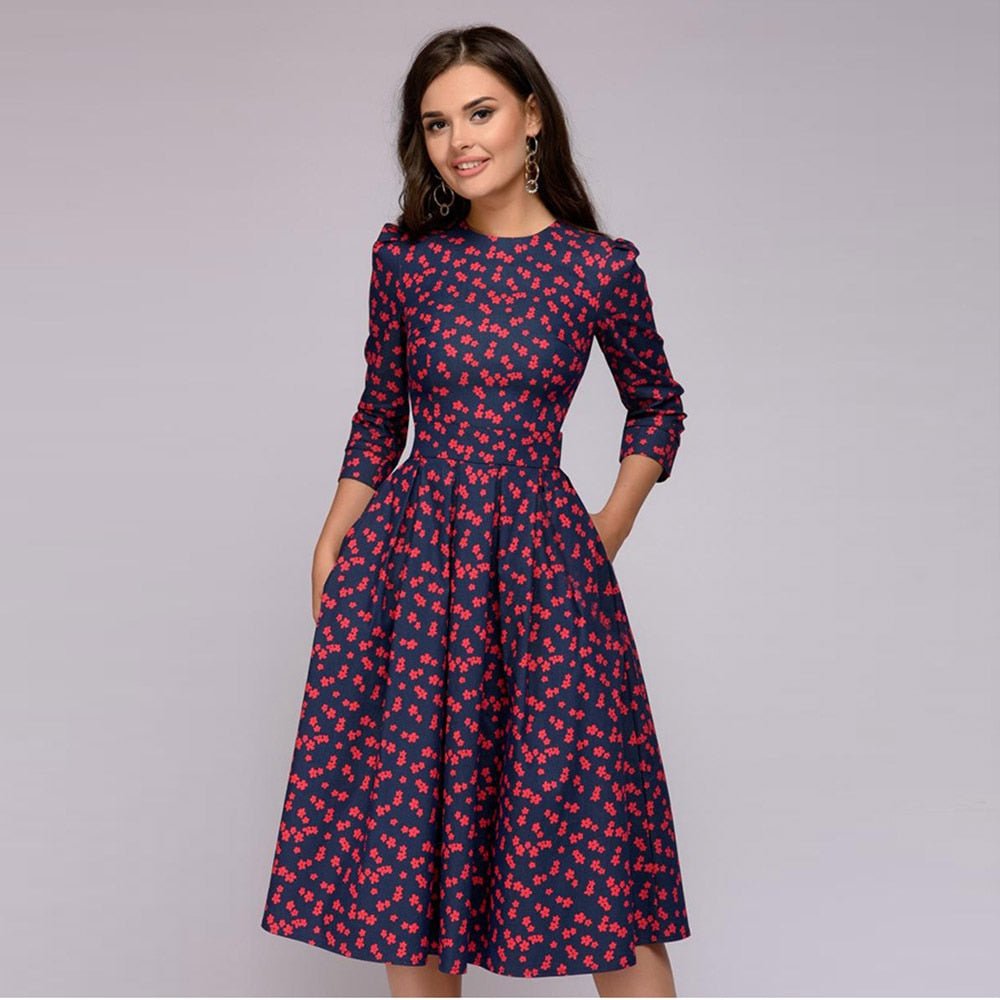 Navy dress with small red motifs and a full skirt.