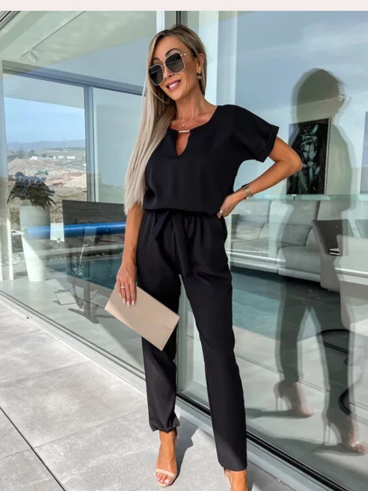 Black short-sleeve jumpsuit with a matching waist tie.