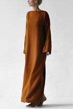 Full front view of a loose rust-coloured maxi dress.