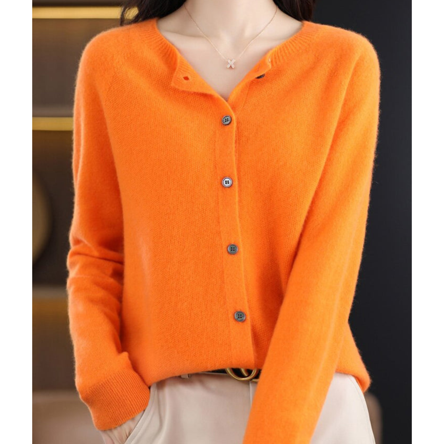 Orange cardigan with the neckline open and buttons down the front.