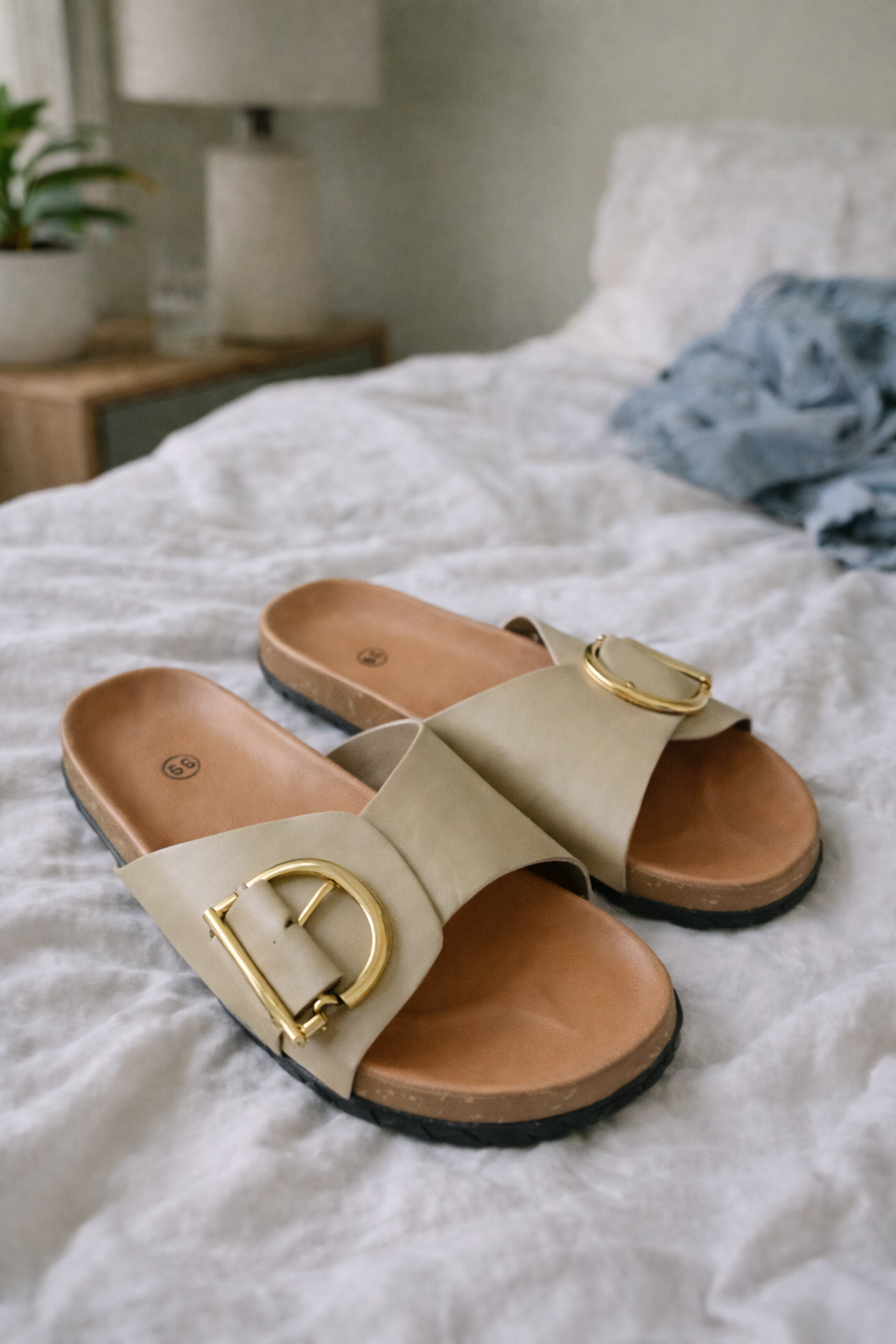 Khaki slides with tan footbeds and D-shaped metal details.