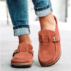 Rust-coloured clogs showing stitched fronts and adjustable straps.