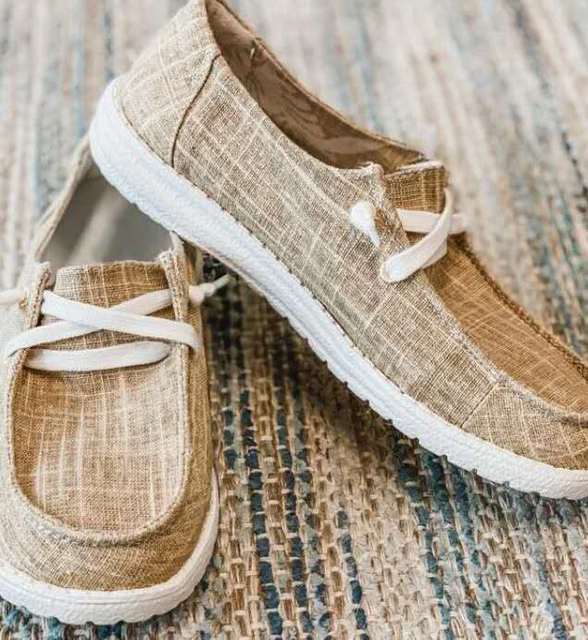 Khaki casual shoes with white laces and pale soles.