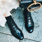 Black lace-up boots worn with white lace clothing.