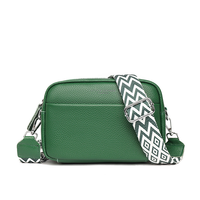 Green shoulder bag with silver-coloured strap clips.