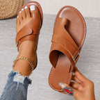 Brown slide sandal held beside the matching sandal with a stitched-edge footbed.