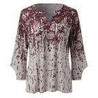 Front view of a red floral split-neck blouse with flared sleeves.
