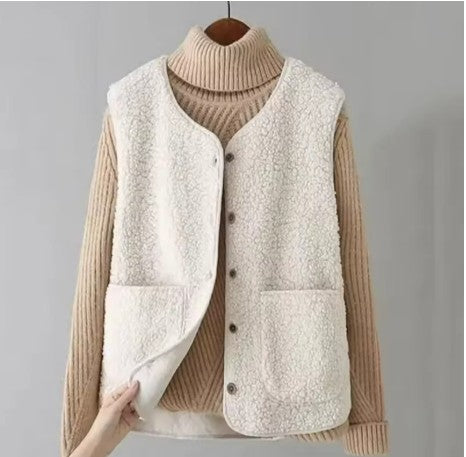 Cream button-front fleece gilet layered over a ribbed jumper.